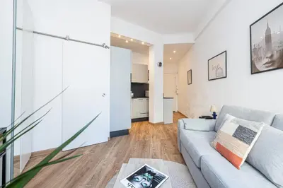 a living room with a couch and a table at 1 GAUTIER 101 - Joli studio equipe - Quartier du Port in Nice