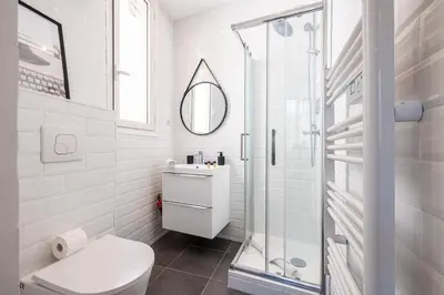 a white bathroom with a toilet and a shower at 1 GAUTIER 101 - Joli studio equipe - Quartier du Port in Nice