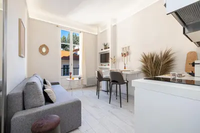 a living room with a couch and a kitchen at 1 GAUTIER 501 - Studio boheme - Quartier du port in Nice
