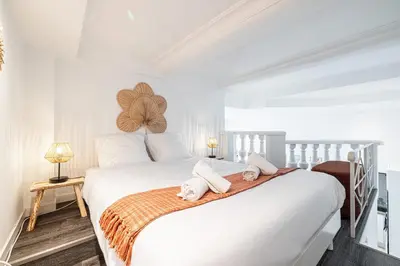 a bedroom with a white bed with towels on it at 1 LONGCHAMP - Joli appartement - Carre d Or - Climatise in Nice