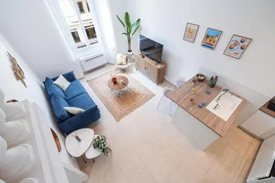 an overhead view of a living room with a blue couch and a table at 1 LONGCHAMP - Joli appartement - Carre d Or - Climatise in Nice