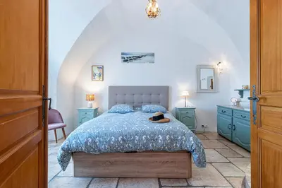 a bedroom with a bed with a blue comforter at 1 SALEYA LOT 2 - Au coeur du Vieux Nice - 1min de la Plage in Nice