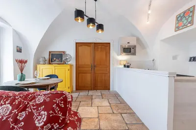a kitchen and a dining room with a table at 1 SALEYA LOT 2 - Au coeur du Vieux Nice - 1min de la Plage in Nice