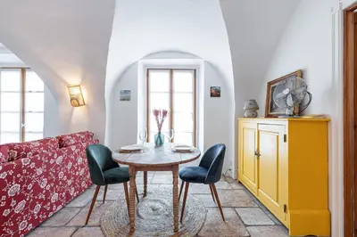 a living room with a table and chairs and a couch at 1 SALEYA LOT 2 - Au coeur du Vieux Nice - 1min de la Plage in Nice