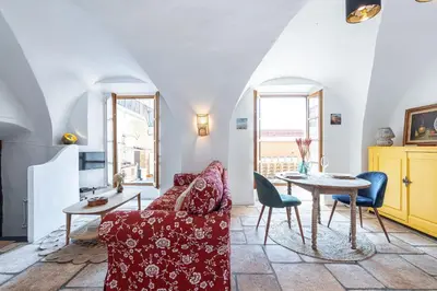 a living room with a red couch and a table at 1 SALEYA LOT 2 - Au coeur du Vieux Nice - 1min de la Plage in Nice