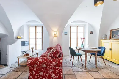 a living room with a red couch and a table at 1 SALEYA LOT 2 - Au coeur du Vieux Nice - 1min de la Plage in Nice