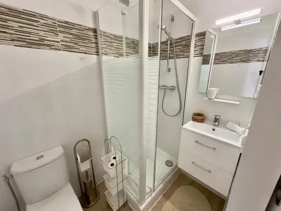 a bathroom with a shower and a toilet and a sink at L'Éclat Safran - Royal Luxembourg in Nice