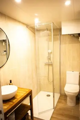 a bathroom with a shower and a toilet and a sink at Appartement La Mezzanine in Nice
