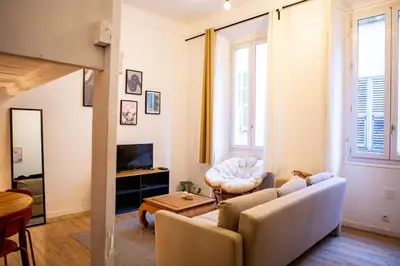 a living room with a couch and a table at Appartement La Mezzanine in Nice