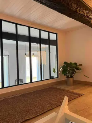 a room with a large window and a potted plant at Appartement La Mezzanine in Nice