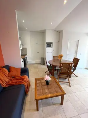 a living room with a couch and a table at Le Village - cosy flat 5 min walk away from sea in Nice