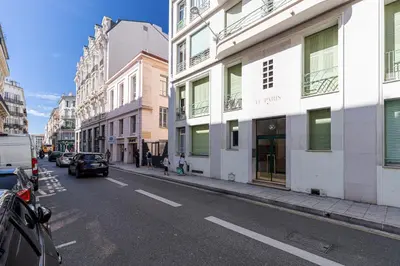 a city street with buildings and a car driving down a street at 37 LAMARTINE - Magnifique Studio Art Deco - Centre-ville in Nice
