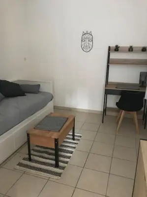 a living room with a couch and a table at Studio lumineux in Nice
