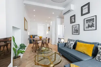 a living room with a blue couch and a table at 37 MASSENA LOT 2 - Superbe 3 pieces - Zone Pietonne - A-C in Nice