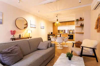 a living room with a couch and a table at COSY VOLTI AP4434 By Riviera Holiday Homes in Villefranche-sur-Mer