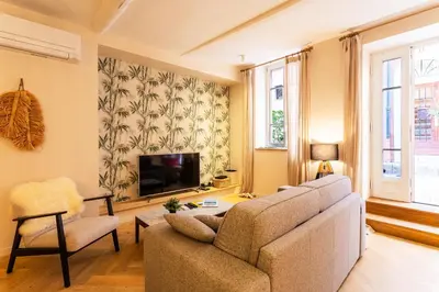 a living room with a couch and a tv at COSY VOLTI AP4434 By Riviera Holiday Homes in Villefranche-sur-Mer