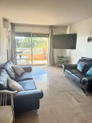 a living room with two couches and a large window at Appartement lumineux Vue Mer, Piscine et tennis in Nice