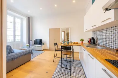 a kitchen and living room with a sink and a counter at Le Carré d'Or - à 2 min à pied du centre-ville in Nice