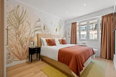 a bedroom with a bed with a painting on the wall at Massenet Dream,Nice in Nice