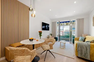 a living room with a couch and a table and chairs at Massenet Dream,Nice in Nice