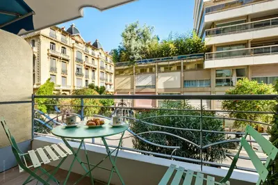 a balcony with a table and chairs and buildings at Massenet Dream,Nice in Nice