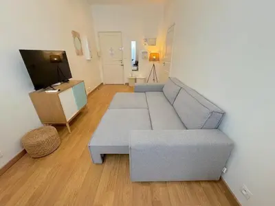 a living room with a couch and a tv at ⁂ Appartement cosy avec balcon 300m de la plage in Nice