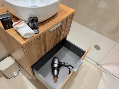a sink in the middle of a bathroom with a gun at ⁂ Appartement cosy avec balcon 300m de la plage in Nice