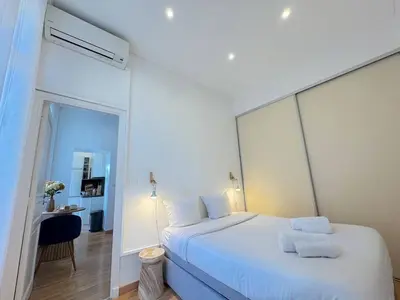 a bedroom with a white bed and a mirror at ⁂ Appartement cosy avec balcon 300m de la plage in Nice