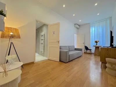 a living room with a couch and a table at ⁂ Appartement cosy avec balcon 300m de la plage in Nice