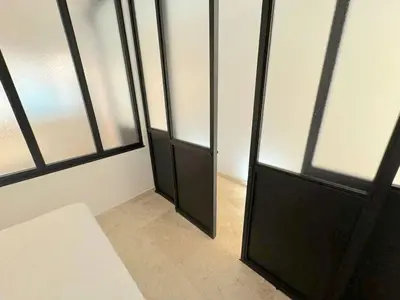 a room with a black door and some windows at ⁂ Magnifique 3P cœur du Vieux Nice in Nice
