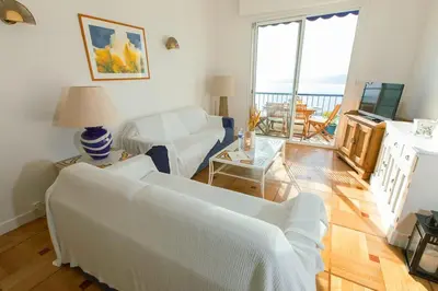 a living room with a couch and a table at Magnifique appartement vue mer Mont Borron in Nice