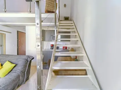 a ladder up to a loft bed in a room at Cosy duplex, hyper centre, wifi,air conditionner in Nice