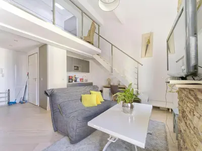 a living room with a couch and a table at Cosy duplex, hyper centre, wifi,air conditionner in Nice