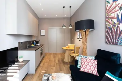 a living room with a couch and a kitchen at #61 1 BDR Rossini Centrale Balcony AC in Nice