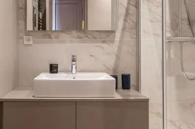 a bathroom with a white sink and a shower at #61 1 BDR Rossini Centrale Balcony AC in Nice