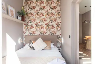 a bedroom with a bed with a floral wallpaper at #61 1 BDR Rossini Centrale Balcony AC in Nice