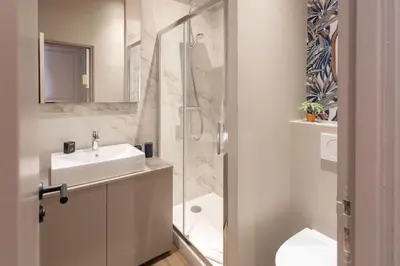 a bathroom with a sink and a glass shower at #61 1 BDR Rossini Centrale Balcony AC in Nice