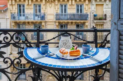 a table with a plate of food on a balcony at #61 1 BDR Rossini Centrale Balcony AC in Nice