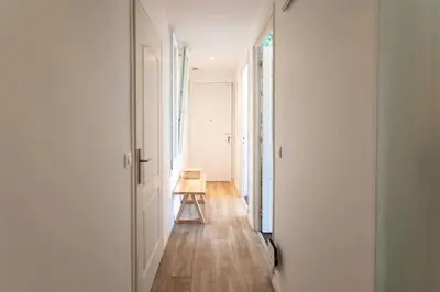 a hallway with a table and a chair in a room at L58 Port Suite 2 BDRS 5mins Old town & Beach Tram in Nice