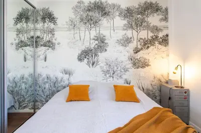 a bed with two orange pillows in a bedroom at L58 Port Suite 2 BDRS 5mins Old town & Beach Tram in Nice