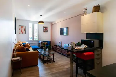 a living room with a couch and a table in it at L58 Port Suite 2 BDRS 5mins Old town & Beach Tram in Nice