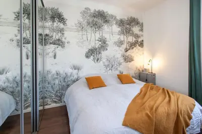 a bed with two orange pillows in a bedroom at L58 Port Suite 2 BDRS 5mins Old town & Beach Tram in Nice