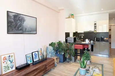 a living room with a tv on the wall at L58 Port Suite 2 BDRS 5mins Old town & Beach Tram in Nice