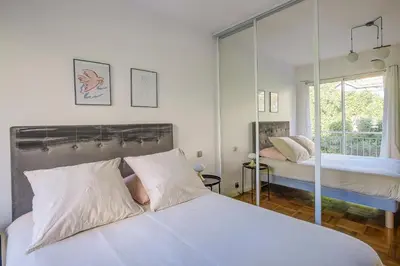 a bedroom with two beds and a large window at Dolce vita in Nice
