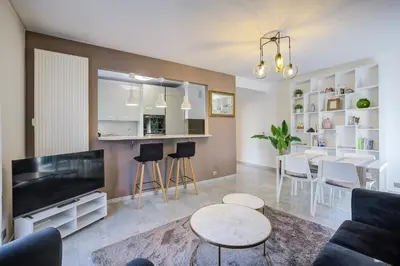 a living room with a television and a dining room at Dolce vita in Nice
