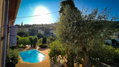 a swimming pool in a yard with a tree at Maison LeFleur in Falicon