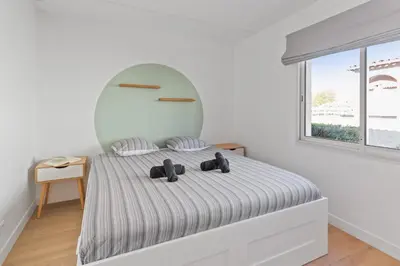 a white bedroom with a bed with two teddy bears on it at Le Cosy - Spacious - AC - WIFI - Hippodrome - Racetracks - Hypercentre in Cagnes-sur-Mer