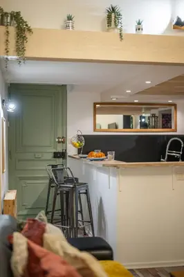 a kitchen with a counter and a green door at Spacieux Loft & Central- Vieux Nice in Nice