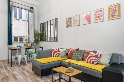 a living room with a couch and a table at Spacieux Loft & Central- Vieux Nice in Nice