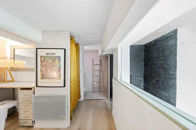 a room with a hallway with a desk and a brick wall at Spacieux Loft & Central- Vieux Nice in Nice
